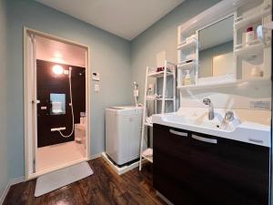 a bathroom with a sink and a toilet and a shower at 内町2階 1フロアまるごと貸切 高松中心部 4名まで in Takamatsu