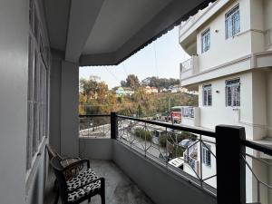 a balcony with a bench and a view of a street at JKR residency in Shillong