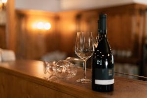 a bottle of wine and a glass on a counter at Sporthotel Kurzras in Maso Corto +18 photos