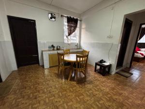 a kitchen with a table and chairs in a room at JKR residency in Shillong