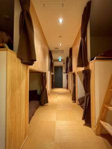 a hallway with a row of bunk beds in a room at hatago STAY Shinmachi in Nakatsugawa
