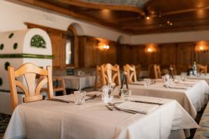 a group of tables with white table cloths on them at Sporthotel Kurzras in Maso Corto