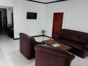 a living room with two couches and a coffee table at Haritha Kanda Rest in Bogawantalawa