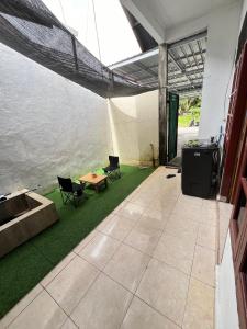a patio with a table and chairs next to the water at Zethira Homestay Syariah in Tabing