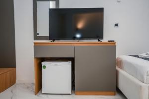 a tv sitting on top of a desk in a room at District&Villa De Lago in Ohrid