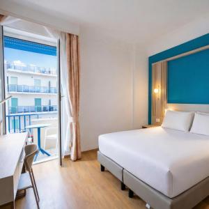 a hotel room with a bed and a balcony at LVG Hotel Collection - Majestic in Alassio +147 photos