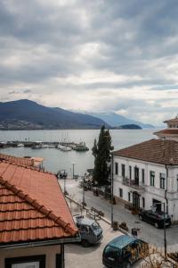 a view of a body of water with buildings and cars at District&Villa De Lago in Ohrid
