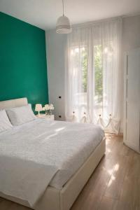 a bedroom with a large bed and a green wall at Enjoy Home Sorrento in Sorrento
