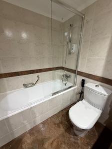 a bathroom with a toilet and a glass shower at Büyük Sümela Otel in Macka +53 photos