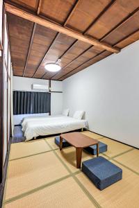 a bedroom with a bed and a coffee table at YAGARA TERRACE HOUSE OSAKA Room A in Osaka