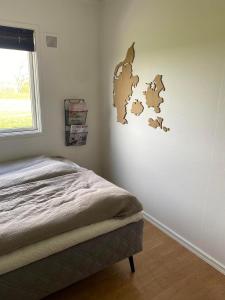 a bedroom with a bed and a wall with a map at Oasen in Nørresundby