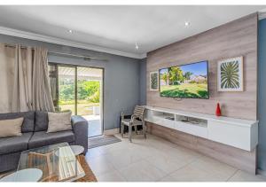 a living room with a couch and a table at Mtunzi Park 18, Scottburgh in Vosburg