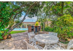 a patio with a table and chairs and a pool at Mtunzi Park 18, Scottburgh in Vosburg