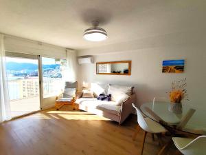 a living room with a couch and a glass table at Isla de los Pensamientos in Faro de Cullera