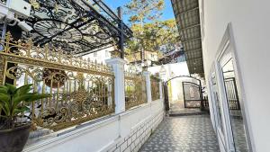 an ornate gold fence next to a street at Mây Villa Garden Đà Lạt in Xuan An