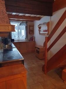 a kitchen with a counter top and a staircase at Haus Pfatschbacher in Wildalpen +6 photos