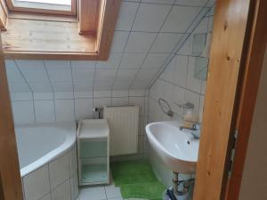 a small bathroom with a sink and a tub at Haus Pfatschbacher in Wildalpen
