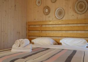a bed with towels and pillows on top of it at Aglamp Almaty in Besqaynar