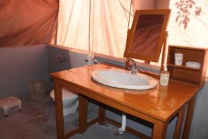 a bathroom with a sink and a toilet at Zero Degree Camps in Joshīmath
