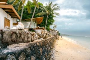 a house on the beach next to the ocean at Kama Haven in Semaya