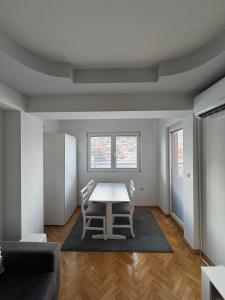 a dining room with a table and two chairs at Apartman Harmony in Ohrid +3 photos