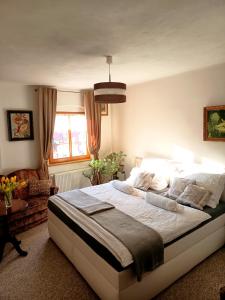 a bedroom with a large bed and a couch at Diviš73 in Loket