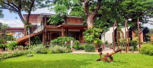 a house with a garden in front of it at บ้านเคียงสะหวัน in Muang Phaluka