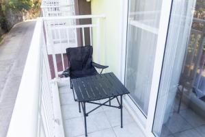a black chair sitting on a balcony at Priscilla Suites Mactan by Amani Grand Resort in Mactan Cebu International