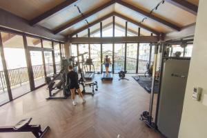 a group of people exercising in a gym at Priscilla Suites Mactan by Amani Grand Resort in Mactan Cebu International