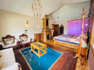 a living room with a bed and a tub in it at Valley homes in Ooty