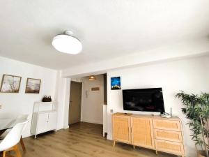 a living room with a flat screen tv on a stand at Isla de los Pensamientos in Faro de Cullera