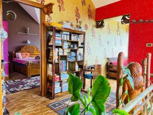 a room with a bed and a book shelf with books at Valley homes in Ooty