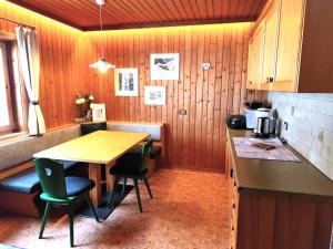 a kitchen with a wooden table and some chairs at Almliesl THUR-746 in Lovara