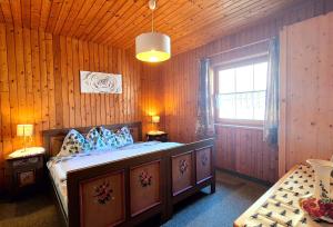 a bedroom with a bed in a wooden room at Almliesl THUR-746 in Lovara