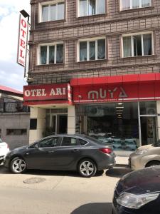 a silver car parked in front of a building at Arı Otel in Erzurum