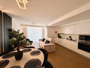 a living room with a couch and a table in a room at Star Light Apartment in Câmara de Lobos