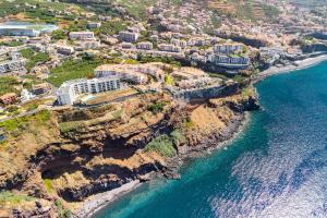 an aerial view of a resort on a cliff near the ocean at Star Light Apartment in Câmara de Lobos