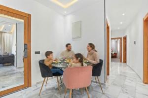 a group of people sitting around a dining room table at OXANA By Atlasia in Agadir