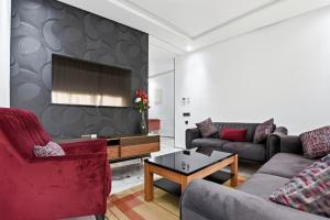 a living room with two couches and a tv at OXANA By Atlasia in Agadir
