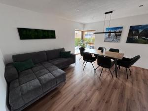a living room with a couch and a table at Alpinelodge8 in Innsbruck