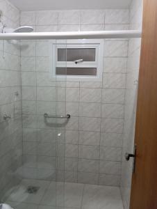 a bathroom with a glass shower with a window at Casa Recanto do Sossego in Antonina +42 photos
