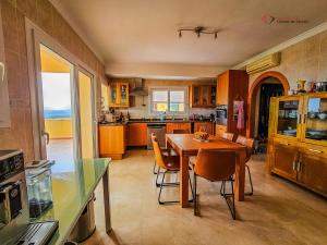 a kitchen with a wooden table and chairs at Diamante Villa Mijas in Mijas