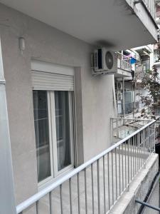 a balcony of a building with a window at Anastasios' artwork apartment in Thessaloniki +12 photos