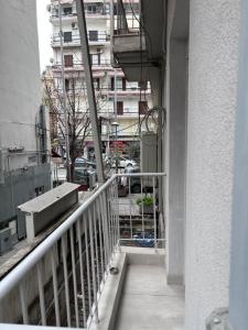 a balcony of a building with a view of a street at Anastasios' artwork apartment in Thessaloniki