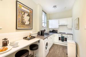 a kitchen with a washer and dryer in it at Cosy town centre cottage in Peebles