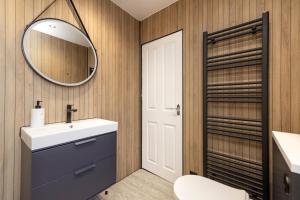 a bathroom with a sink and a mirror at Cosy town centre cottage in Peebles +8 photos