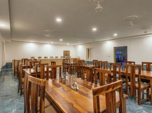 a large room with wooden tables and chairs at Limra Desert Camp With Swimming pool in Jaisalmer