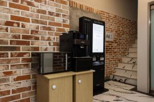 a brick wall with several microwaves on top of cabinets at Bucheon Daon Hotel in Bucheon