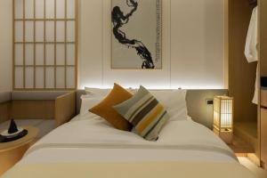 a bed with white sheets and pillows in a room at Bucheon Daon Hotel in Bucheon +69 photos