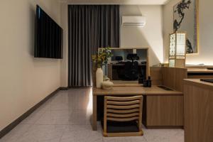 a kitchen with a table with a vase of flowers on it at Bucheon Daon Hotel in Bucheon